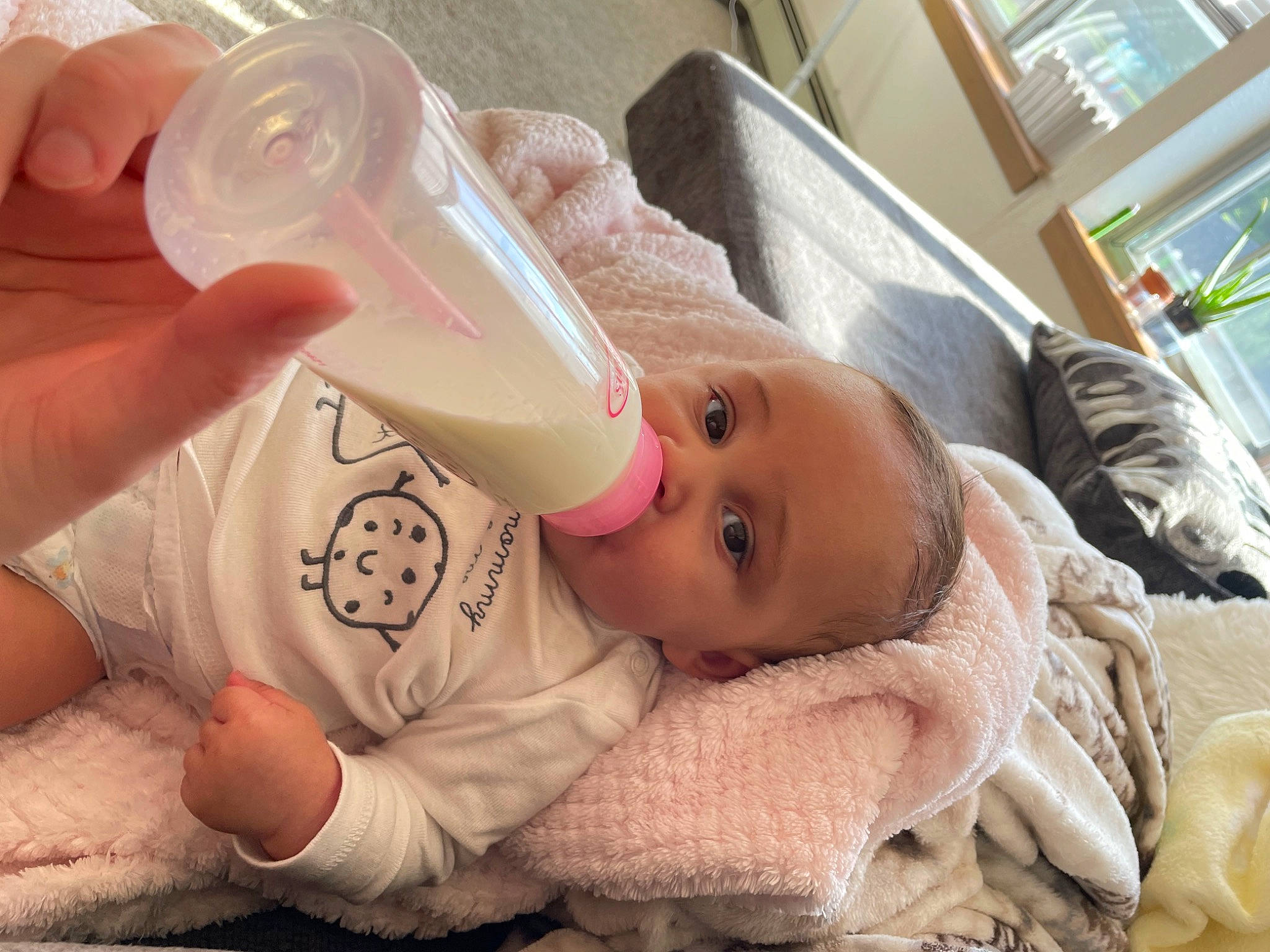 Maylani is registered to the contest to win money with this photo: baby, baby_bottle, baby_bottle_feeding, baby_toddler_clothing, bottle, cheek, drinkware, eyelash, finger, grain_milk, hand, infant_formula, milk, nose, person, plant_milk, plastic_bottle, raw_milk, skin, soy_milk