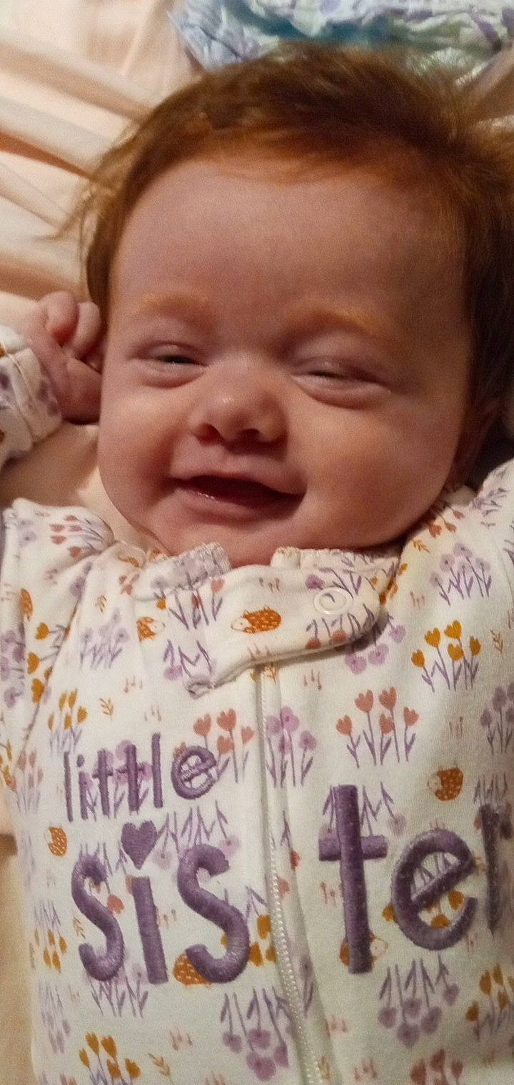 Khaleesia is registered to the contest to win money with this photo: baby_toddler_clothing, cheek, ear, eyebrow, eyelash, finger, forehead, happy, human_body, iris, lip, mammal, mouth, nose, person, photograph, pink, skin, sleeve, smile