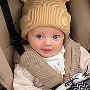 Jude joined the competition — help win amazing prizes! baby, child, hat, beige, stroller, toy, cute, infant, face, blue_eyes, clothing, warm, seatbelt, smile, portrait, closeup, childrenswear, baby_toy, car_seat, adorable