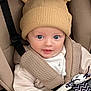 baby, child, hat, beige, stroller, toy, cute, infant, face, blue_eyes, clothing, warm, seatbelt, smile, portrait, closeup, childrenswear, baby_toy, car_seat, adorable