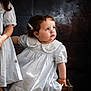 Zineb a rejoint le concours — aidez-le/la à gagner de superbes lots ! toddler, child, girl, dress, blue_dress, wooden_crate, curly_hair, hair_clip, pensive, holding_hand, portrait, studio, indoor, sitting, looking_up, cute, baby, person, children, photography