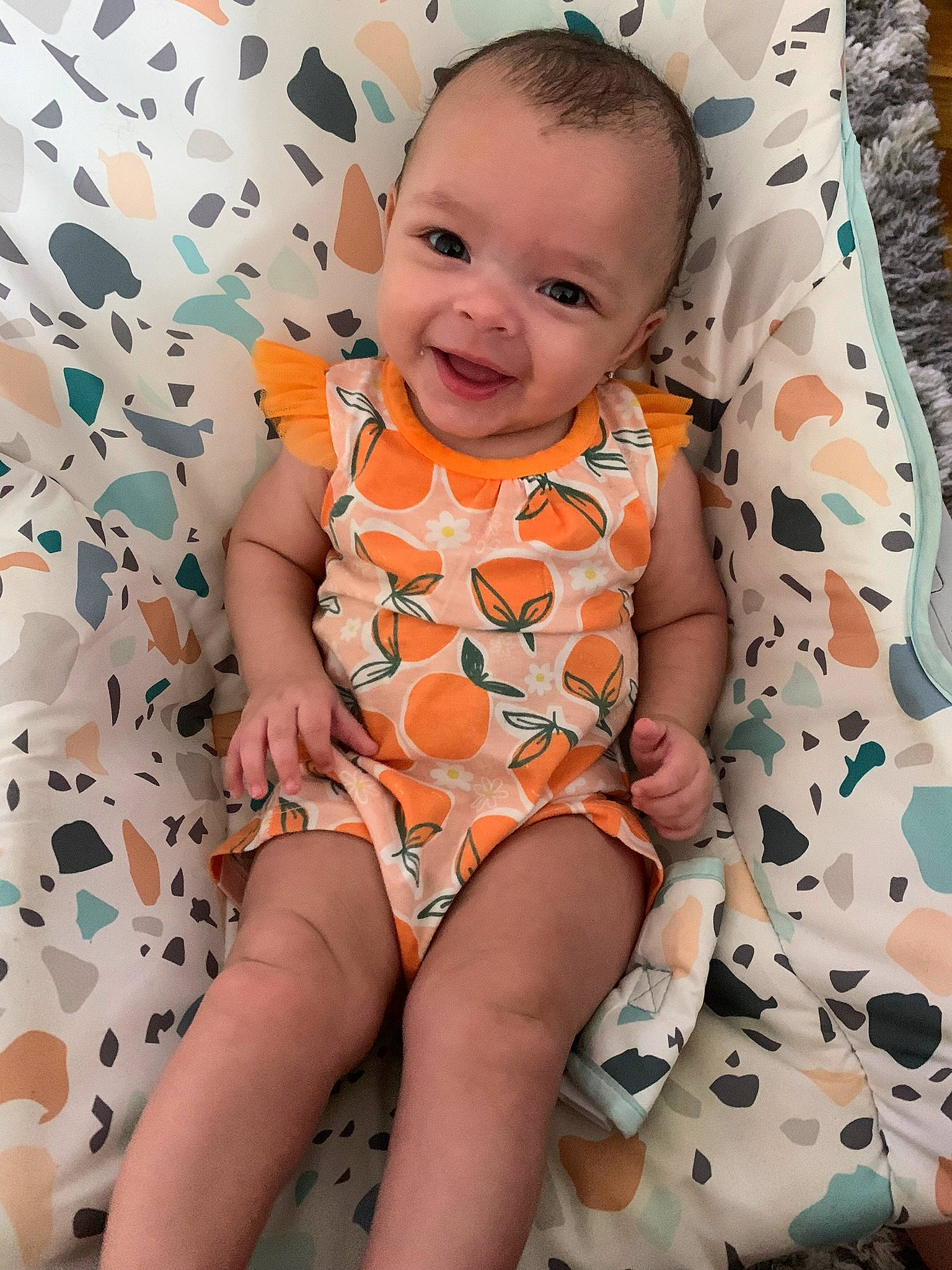 Anaya Reign joined the competition — help win amazing prizes! arm, baby, baby_toddler_clothing, child, comfort, eye, face, finger, happy, head, joy, orange, person, photograph, pink, skin, sleeve, smile, textile, thigh
