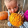 Wesley joined the competition — help win amazing prizes! baby, pumpkin, orange, bumpy, straw, wooden_fence, child, sitting, curious, clothing, sock, overalls, close_up, fall, harvest, cute, outdoor, head, hands, face