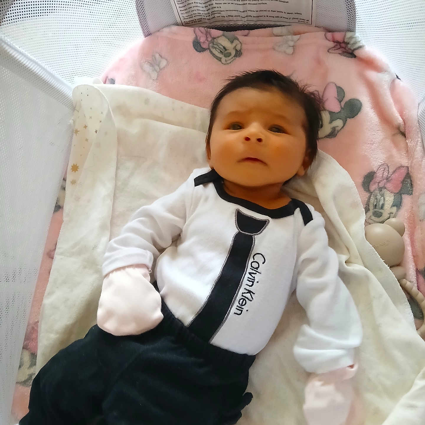 Remi Lee Alexander joined the competition — help win amazing prizes! baby, infant, calvin_klein, blanket, minnie_mouse, playpen, cute, clothing, soft_toys, white_gloves, black_pants, lying_down, indoor, child, person, face, head, newborn, comfort, pink
