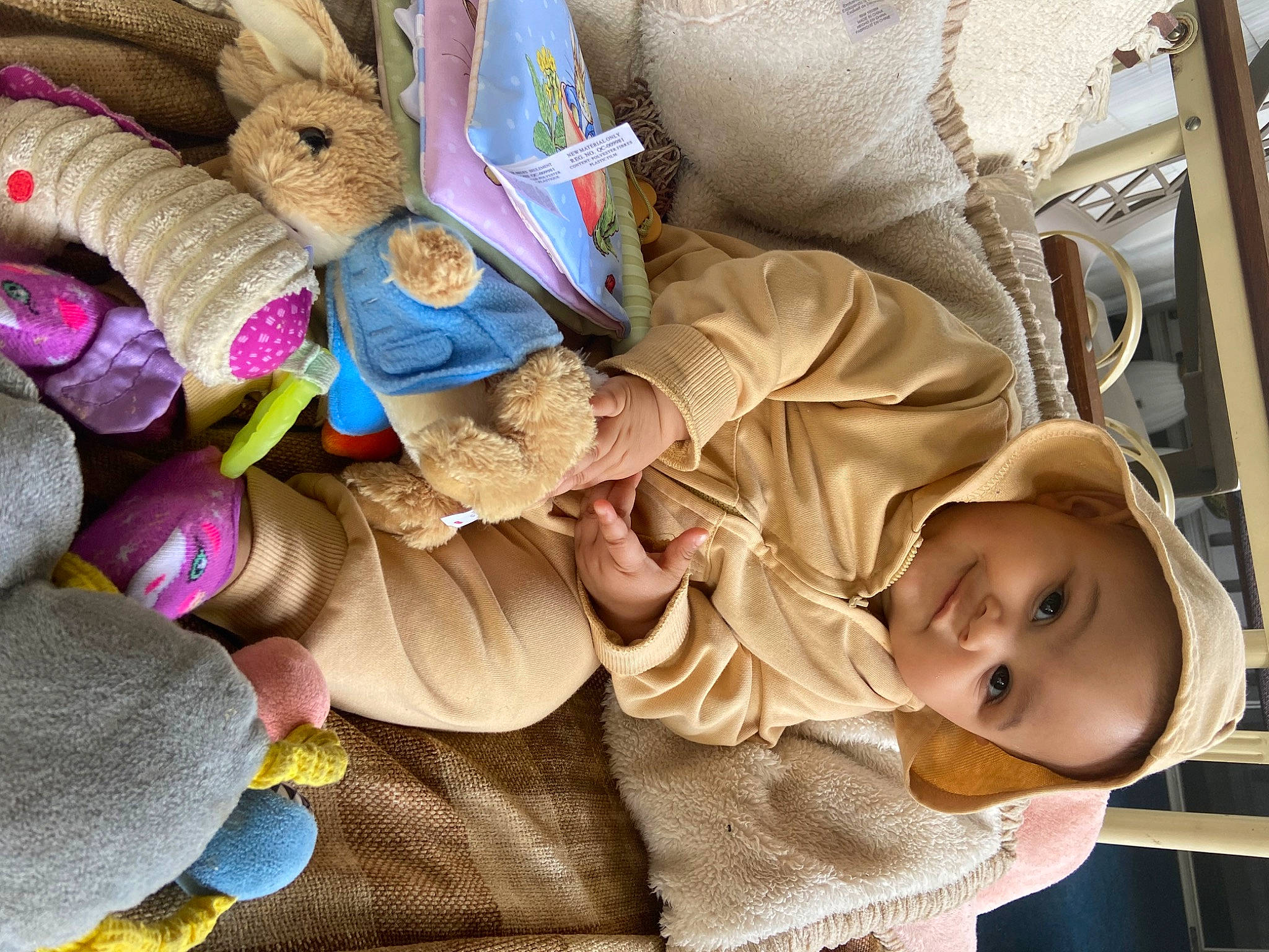 Amiyah is registered to the contest to win money with this photo: baby, baby_products, baby_toddler_clothing, child, comfort, happy, hat, headgear, human_body, linens, pattern, person, sitting, smile, thread, toddler, tree, wood, wool, woolen