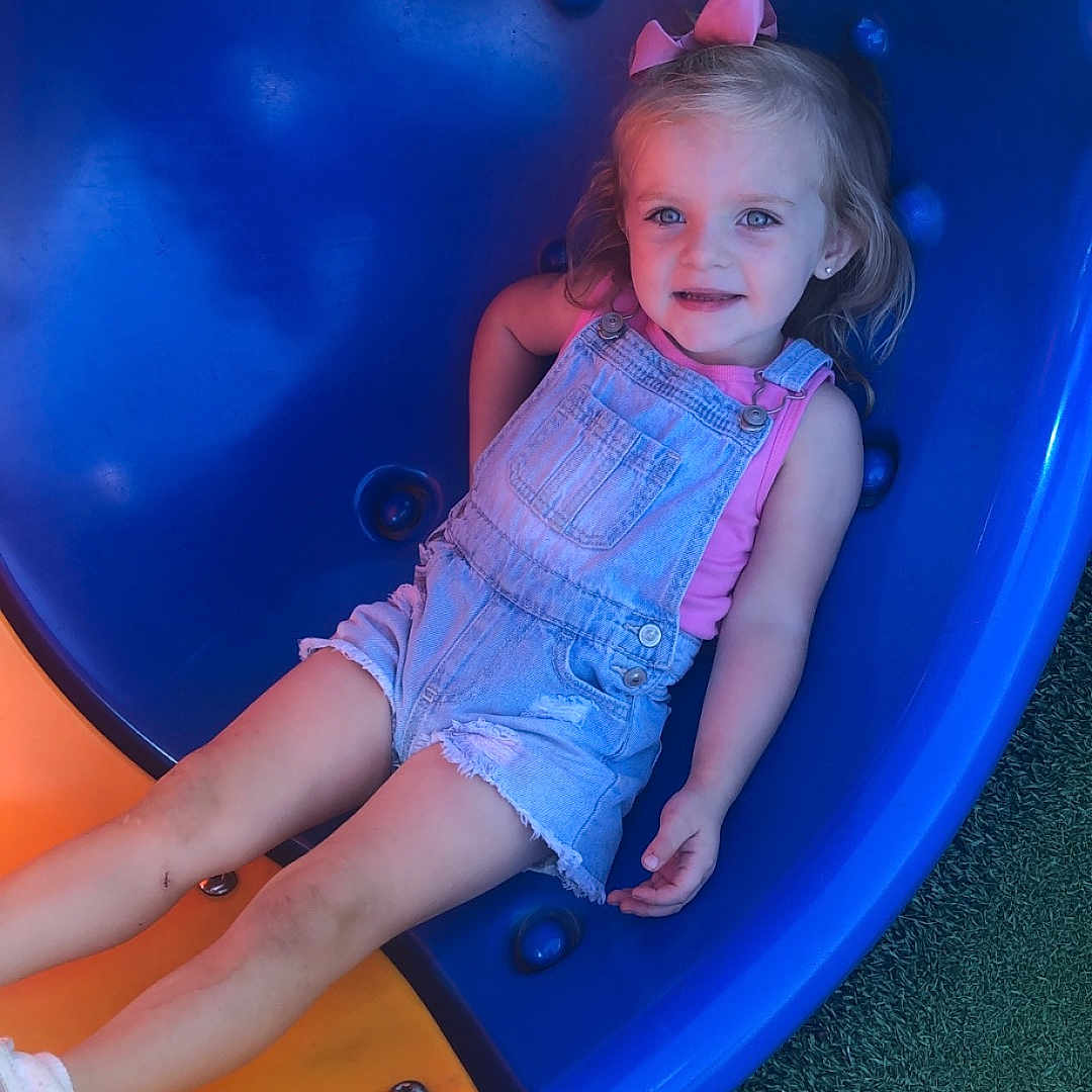 Delanie joined the competition — help win amazing prizes! baby, clothing, face, footwear, grass, head, indoors, outdoorplayarea, outdoors, pants, person, photography, plant, playarea, portrait, shoe, shorts, slide, summer, toy