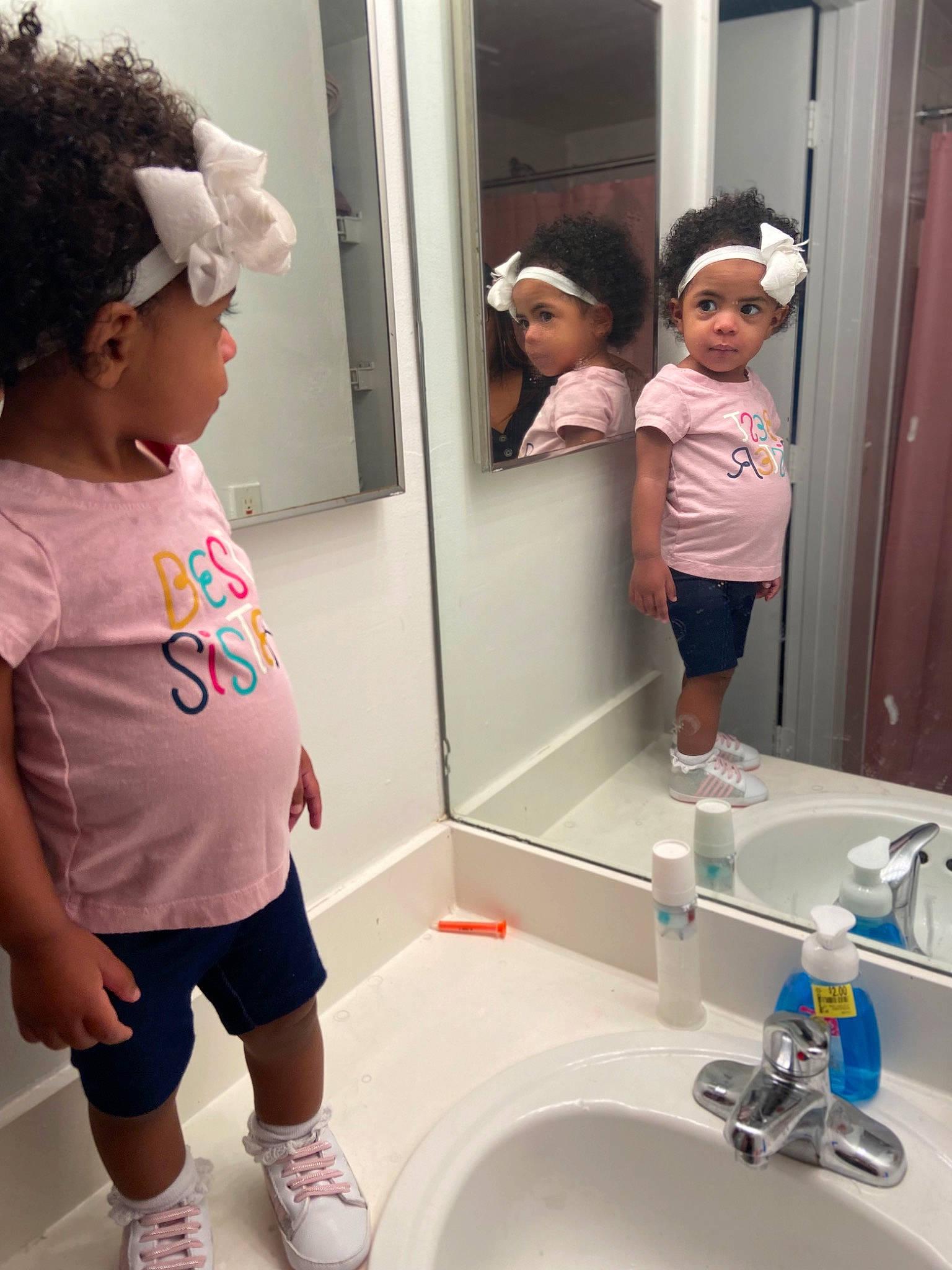 Angela joined the competition — help win amazing prizes! bathroom, beauty, black, cleanliness, fluid, headwear, household_supply, material_property, mirror, person, photograph, pink, plumbing, plumbing_fixture, purple, shorts, sink, sleeve, snapshot, tap