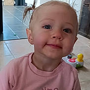 Neïra a rejoint le concours — aidez-le/la à gagner de superbes lots ! toddler, child, girl, pigtails, pink_shirt, toy, indoor, kitchen, smile, face, person, cute, young_child, playful, floor_tiles, cabinet, appliance, earrings, long_sleeve, curious