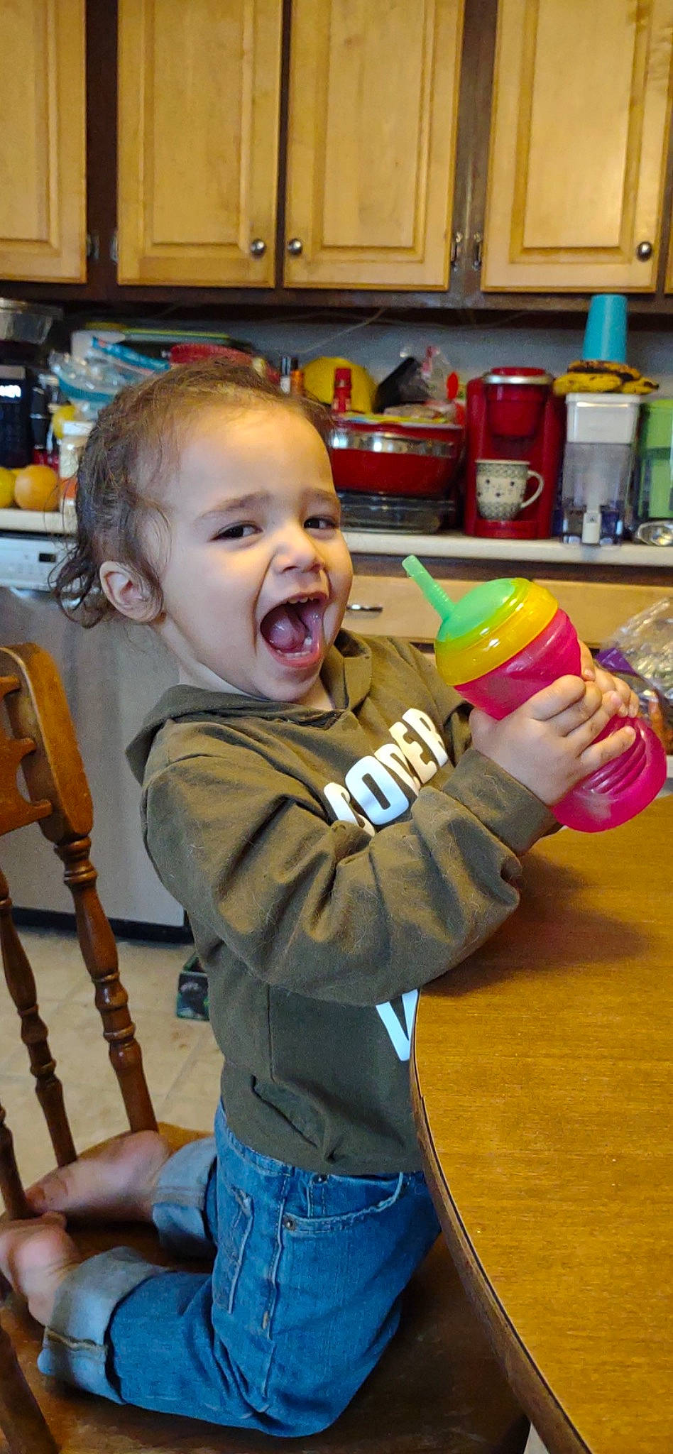 Javier is registered to the contest to win money with this photo: baby, baby_toddler_clothing, cheek, child, clothing, denim, drinkware, fun, happy, laugh, person, play, room, shelf, sitting, sleeve, smile, t_shirt, tableware, toddler