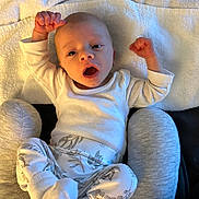 Marshall joined the competition — help win amazing prizes! baby, infant, towel, white_clothing, patterned_pants, socks, face, arms_raised, lying_down, soft_texture, curious_expression, indoors, child, person, head, small_hands, blanket, comfortable, resting, cute