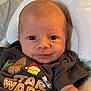 Marshall is registered to the contest to win money with this photo: baby, infant, face, eyes, shirt, star_wars, clothing, pillow, soft, cute, portrait, child, young, smiling, indoors, person, head, expression, toddler, apparel