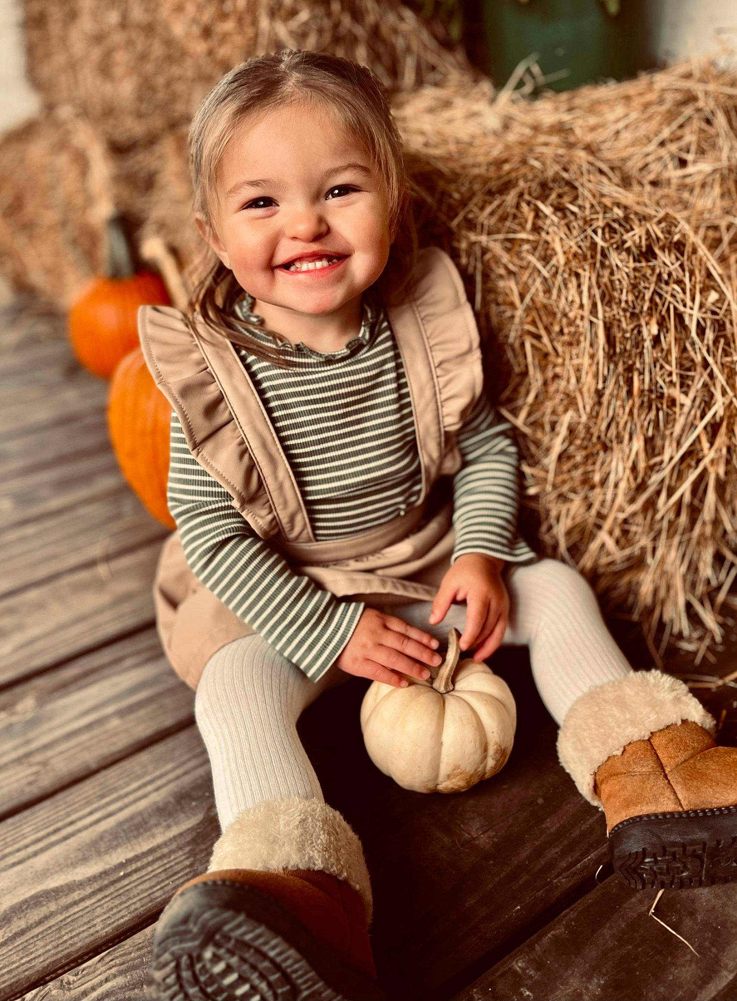Sereniti is registered to the contest to win money with this photo: arm, blond, child, face, flash_photography, grass, hair, happy, human_body, human_leg, joy, knee, people_in_nature, person, pumpkin, shoe, sitting, smile, thigh, toddler
