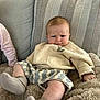 Archie is registered to the contest to win money with this photo: baby, blanket, child, comfort, cushion, cute, expression, face, furniture, indoor, infant, pants, person, relax, serious, skin, socks, sofa, sweater, young