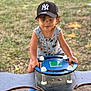 baseball_cap, blue, boy, cap, child, clothing, daylight, feet, footwear, fun, grass, happy, mickey_mouse, outdoor, playground, smiling, spring_rider, summer, toddler, toy
