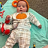 Kaydence is registered to the contest to win money with this photo: baby, child, infant, lying_down, portrait, pumpkin, autumn, knit_hat, sweater, plaid, play_mat, toy, stuffed_animal, rattle, colorful, indoor, carpet, happy, face, photography