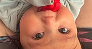Kaydence is registered to the contest to win money with this photo: baby, child, infant, portrait, upside_down, smiling, eyes, face, red_toy, toy, hands, long_sleeves, clothing, dark_hair, lying_down, indoor, close_up, playful, cozy, photography