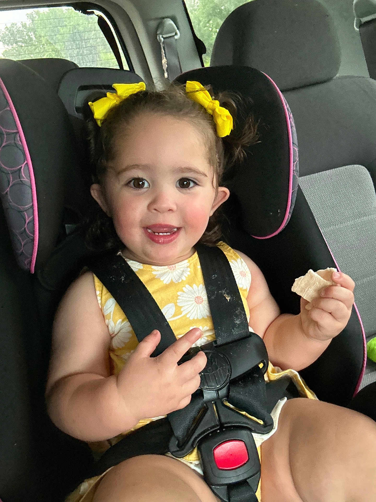 Cheyenne is registered to the contest to win money with this photo: toddler, child, car_seat, yellow_bows, yellow_dress, smiling, snack, seatbelt, safety, car_interior, cute, happy, baby, hair_bows, child_safety, portrait, young_child, seat, baby_girl, indoors