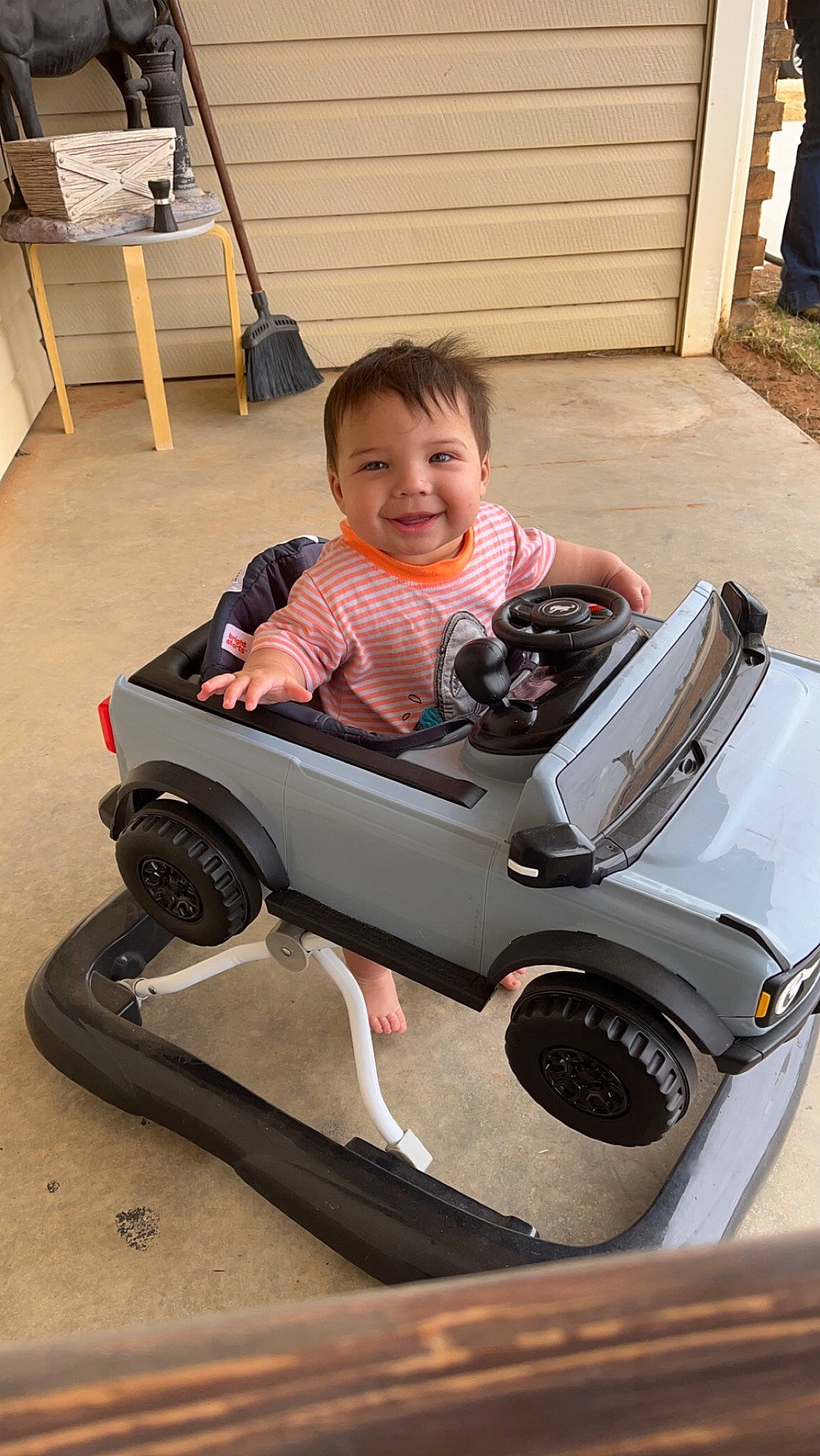 Brentley is registered to the contest to win money with this photo: auto_part, automotive_design, automotive_exterior, automotive_tire, baby_toddler_clothing, bumper, child, comfort, fun, joy, lap, leisure, motor_vehicle, person, sitting, smile, tire, toddler, travel, vehicle