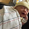 baby, blanket, bottle, care, clothing, comfort, couch, hat, holding, hospital, indoor, infant, newborn, parent, person, relaxation, resting, sleeping, smile, wristband