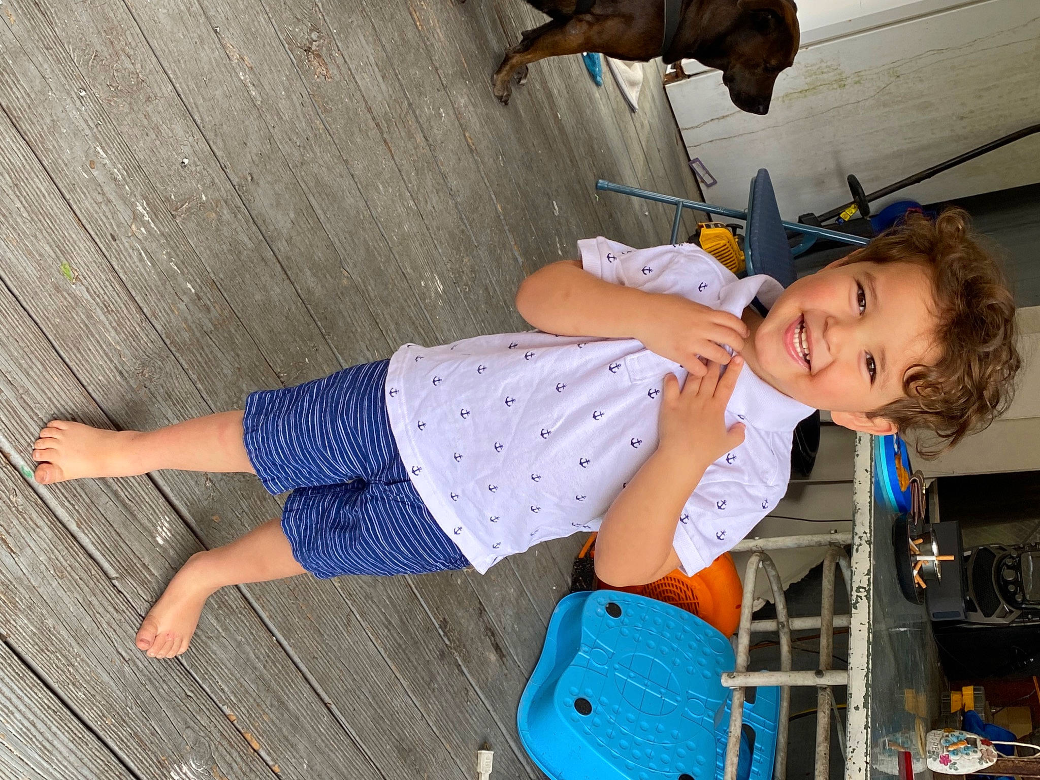 Eli is registered to the contest to win money with this photo: baby_toddler_clothing, child, elbow, electric_blue, flooring, foot, fun, human_leg, joint, joy, knee, leisure, pattern, person, sandal, sitting, sock, thigh, toddler, waist