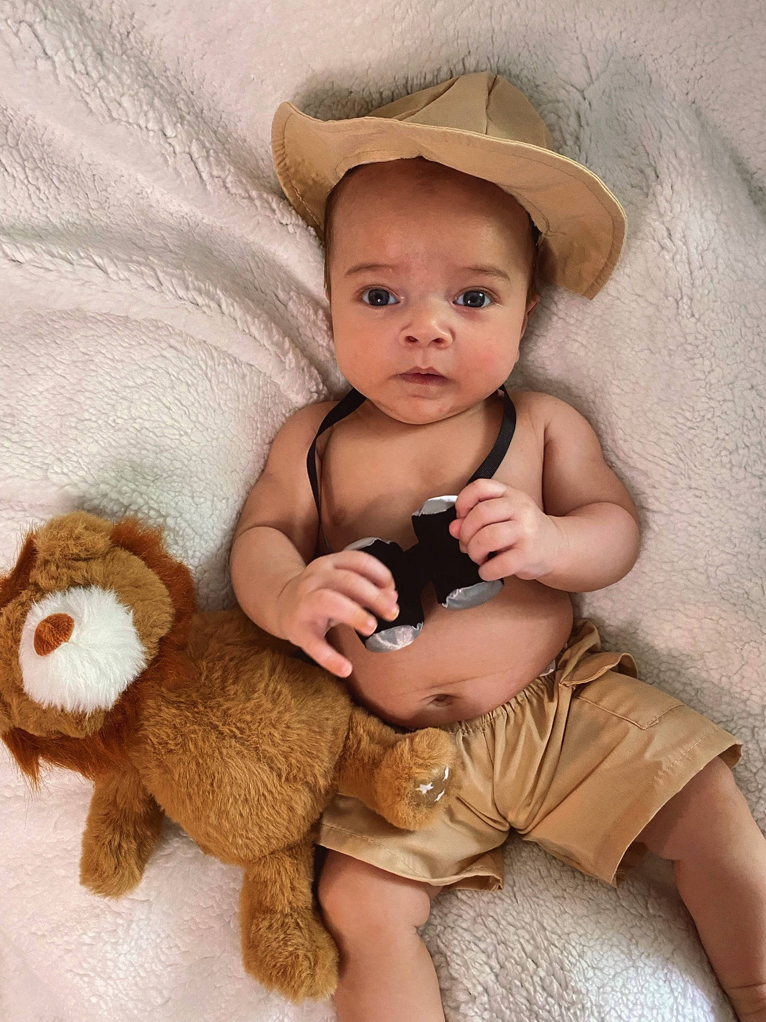 Jalen is registered to the contest to win money with this photo: abdomen, baby, baby_toddler_clothing, brown_hair, child, comfort, eye, flash_photography, fur, hat, human_leg, person, sitting, skin, stuffed_toy, sun_hat, thigh, toddler, toy, trunk