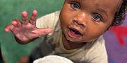 Kazrin is registered to the contest to win money with this photo: child, toddler, curious, reaching_hand, face, eyes, indoor, soft_focus, close_up, person, skin, hair, clothing, expression, background, colorful, blurry, portrait, cute, young