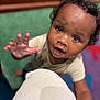 Kazrin is registered to the contest to win money with this photo: child, toddler, curious, reaching_hand, face, eyes, indoor, soft_focus, close_up, person, skin, hair, clothing, expression, background, colorful, blurry, portrait, cute, young