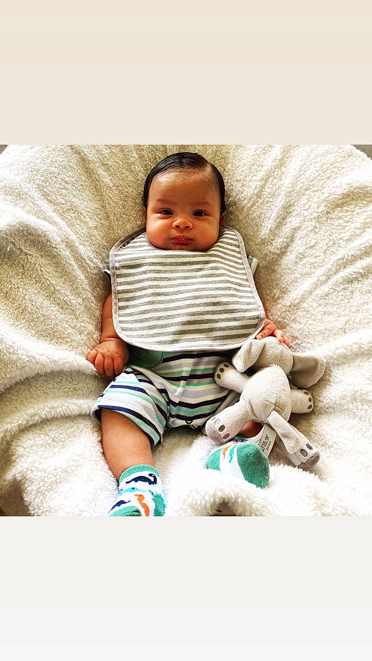 Marcel joined the competition — help win amazing prizes! baby, baby_products, baby_toddler_clothing, child, comfort, foot, happy, human_body, human_leg, knee, linens, pattern, person, product, sitting, sleeve, sock, t_shirt, textile, thigh