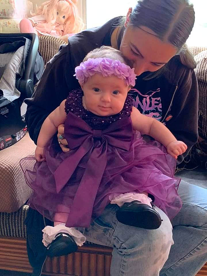 Daisy is registered to the contest to win money with this photo: baby, bag, cap, chair, child, cool, event, fashion_accessory, fun, happy, headwear, interaction, luggage_and_bags, magenta, person, photograph, pink, purple, sitting, snapshot