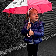 Thylia a rejoint le concours — aidez-le/la à gagner de superbes lots ! black_leggings, boots, cat_ears, chain_link_fence, child, color_pop, cute, fall_leaves, girl, headband, hedge, outdoor, pavement, pink, playful, portrait, puffer_jacket, standing, umbrella, winter_clothing