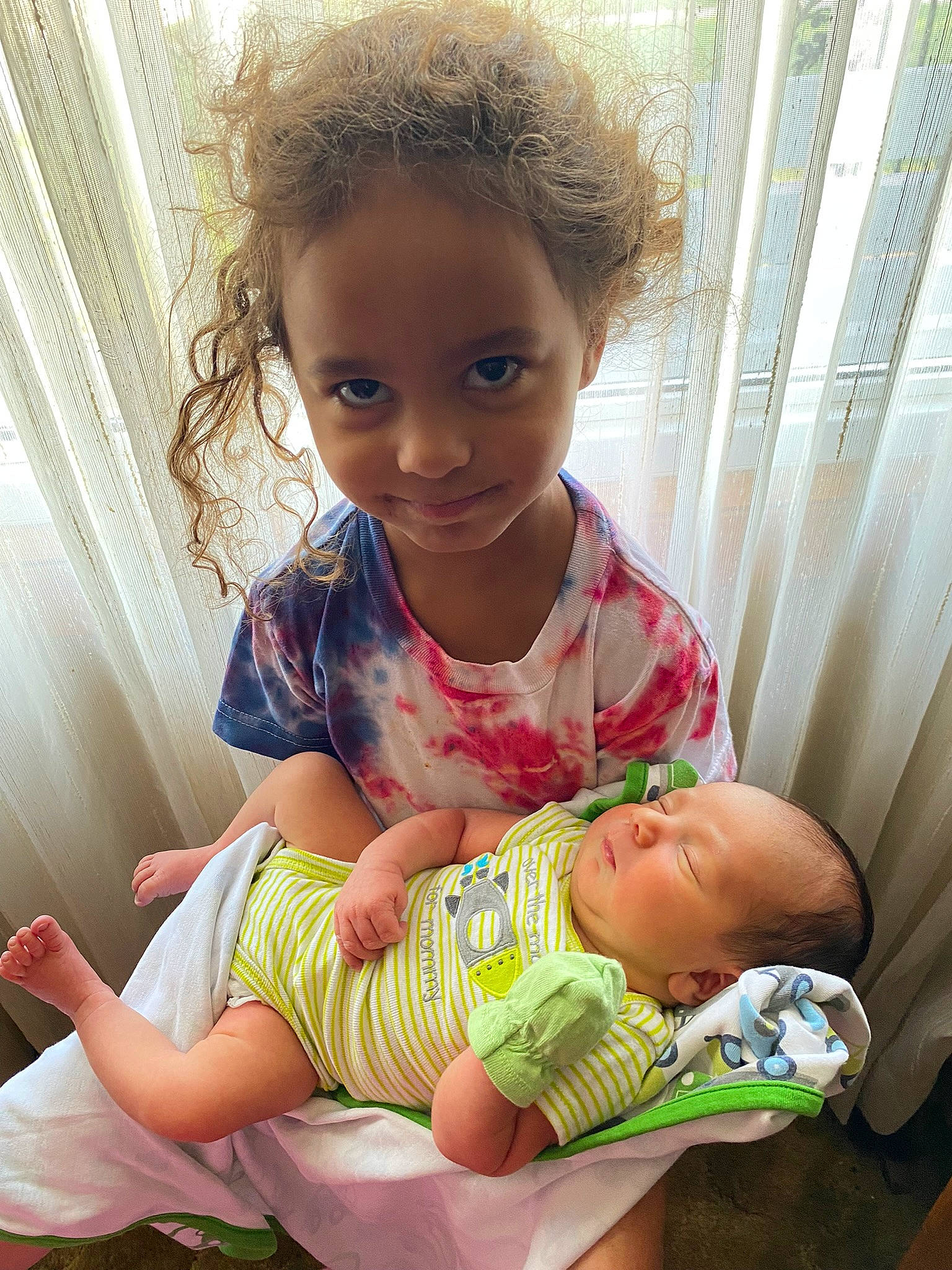 Braelyn is registered to the contest to win money with this photo: abdomen, baby, baby_toddler_clothing, cheek, chest, child, comfort, curtain, eye, finger, foot, happy, human_body, joy, organ, person, sitting, skin, smile, thigh