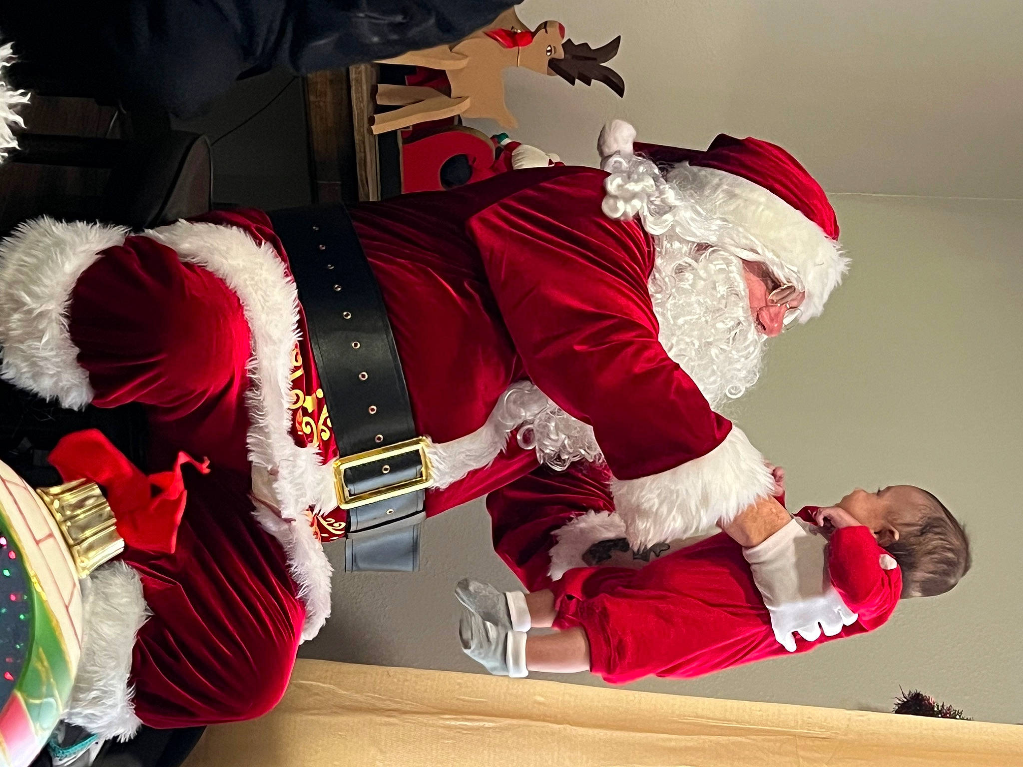 Dedrick is registered to the contest to win money with this photo: carmine, christmas, christmas_decoration, christmas_eve, costume, costume_hat, event, fictional_character, fun, fur, gesture, hat, holiday, lap, person, red, santa_claus, sleeve, tradition