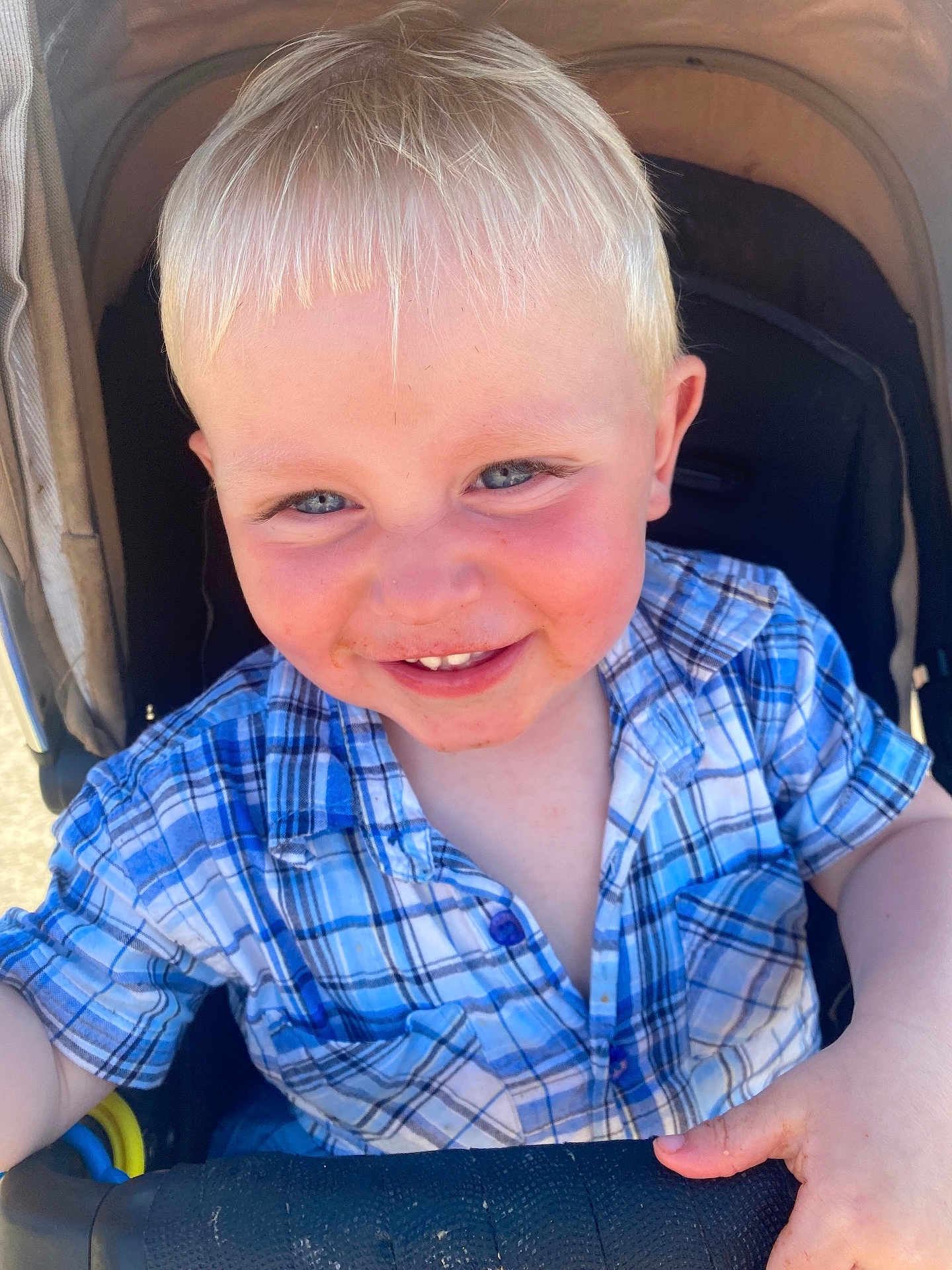 Robin joined the competition — help win amazing prizes! child, toddler, smiling, blue_eyes, blond_hair, plaid_shirt, stroller, outdoor, sunlight, happy, face, hand, clothing, casual, baby, person, cute, portrait, young, playful