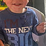 Robin joined the competition — help win amazing prizes! toddler, child, smiling, high_chair, cereal, bowl, spoon, breakfast, indoor, blue_shirt, face, happy, food, mealtime, person, cute, young_child, eating, table, front_view