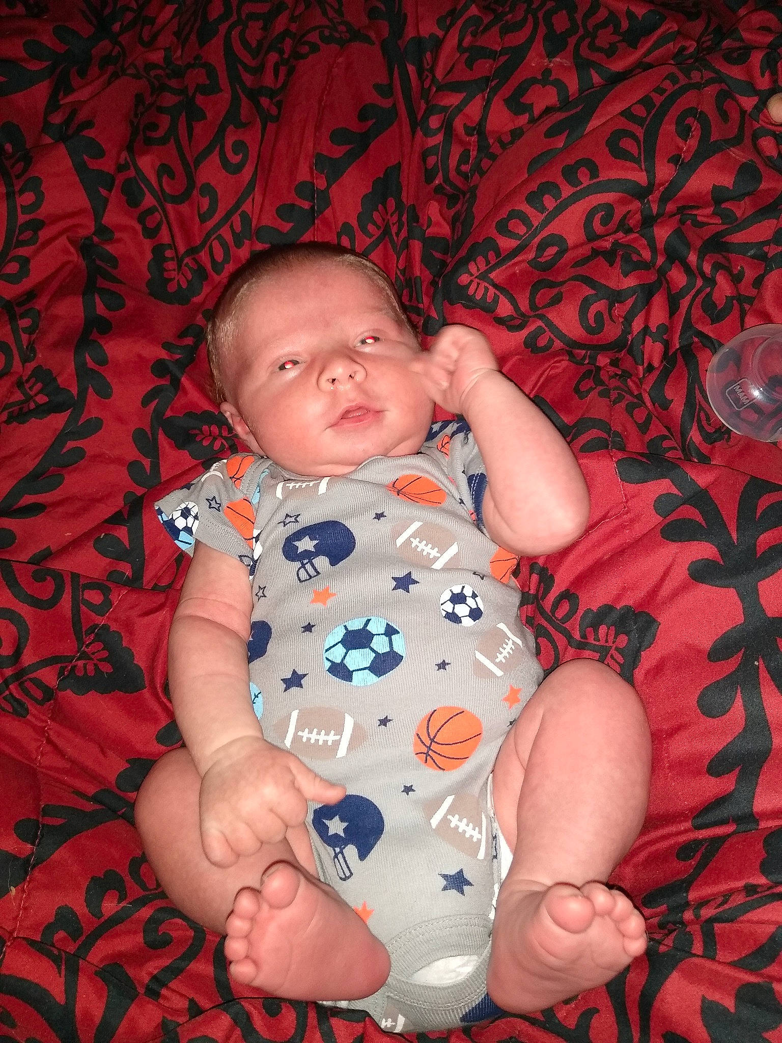 Kyle is registered to the contest to win money with this photo: azure, baby, baby_toddler_clothing, cheek, child, comfort, facial_expression, finger, flash_photography, fun, happy, muscle, pattern, person, pink, red, sitting, skin, sleeve, textile