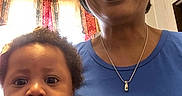 Kyra Bromell joined the competition — help win amazing prizes! baby, woman, person, indoor, portrait, curly_hair, knitted_sweater, blue_shirt, necklace, window, curtains, smile, face, child, family, closeup, expression, skin, head, home