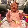 Kyra Bromell joined the competition — help win amazing prizes! baby, child, pink_dress, headband, walker, smiling, indoor, couch, pillows, toy, happy, infant, cute, seated, playful, furniture, home, girl, face, portrait