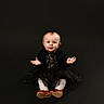 baby, child, sitting, black_dress, red_shoes, sparkly, portrait, studio, curious, cute, expression, hands, isolated, background, infant, young_child, fashion, smile, female, indoor