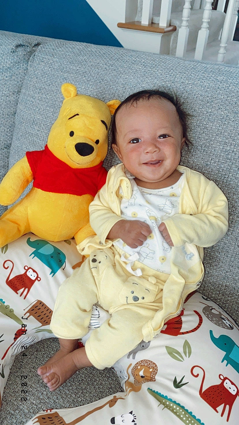 Alijah is registered to the contest to win money with this photo: baby, baby_toddler_clothing, cheek, child, comfort, facial_expression, finger, fun, happy, head, joy, linens, organ, person, product, skin, sleeve, smile, teddy_bear, textile