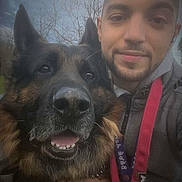 Wolf participe au concours pour gagner de l'argent avec cette photo : animal, bond, casual_clothing, closeup, daytime, dog, face, friendship, german_shepherd, happy, leash, man, nature, outdoor, pet, portrait, selfie, sky, smiling, tree