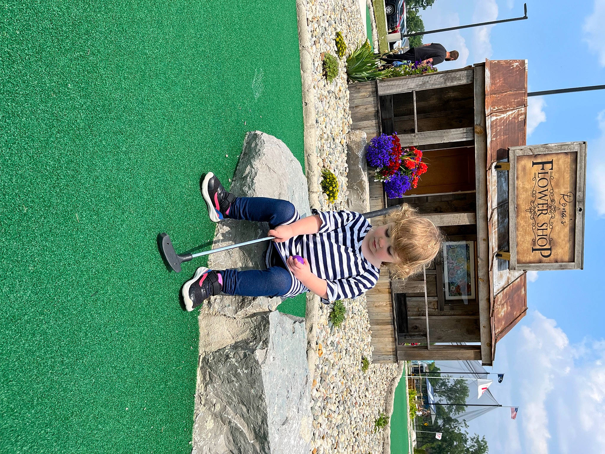 Alice is registered to the contest to win money with this photo: city, cloud, facade, fun, grass, green, houseplant, leisure, line, pedestrian, person, plant, room, shadow, sky, street, toddler, tree, urban_design, wall