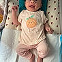 Anna a rejoint le concours — aidez-le/la à gagner de superbes lots ! baby, infant, smiling, clothing, onesie, pants, changing_pad, apple_pattern, face, head, hands, feet, indoors, bed, blanket, happy, cute, child, person, portrait