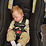 baby, sleeping, car_seat, infant, straps, clothing, white_socks, beige_pants, cream_sweater, hair, face, peaceful, child, black_car_seat, safety, seatbelt, newborn, cute, indoors, resting