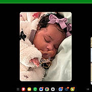 Cherish joined the competition — help win amazing prizes! baby, sleeping, pacifier, bow, curly_hair, blanket, face, person, indoor, car, video_call, man, child, peaceful, portrait, close_up, clothing, head, expression, technology