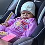baby, car_seat, child, clothing, hat, knit_hat, purple_outfit, winnie_the_pooh, tigger, toddler, seatbelt, indoor, portrait, cute, child_seat, infant, face, person, pout, soft_light