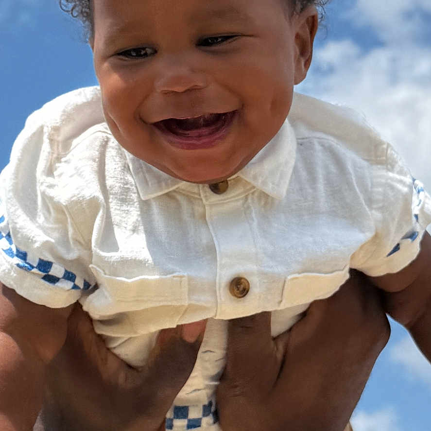 Elijah joined the competition — help win amazing prizes! baby, babylaughing, bodypart, clothing, face, finger, frown, hand, happy, head, laughing, mouth, pants, person, photography, portrait, shirt, shorts, smile, teeth