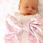 Eleanor joined the competition — help win amazing prizes! baby, blanket, bow, closeup, cozy, eyelids, fabric, face, fluffy_background, head, infant, mouth, newborn, peaceful, pink, portrait, skin, sleeping, soft_texture, swaddle