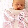 baby, blanket, bow, closeup, cozy, eyelids, fabric, face, fluffy_background, head, infant, mouth, newborn, peaceful, pink, portrait, skin, sleeping, soft_texture, swaddle