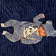 Jeremy is registered to the contest to win money with this photo: baby, infant, blue_clothing, hat, bear_ears, blanket, lying_down, cute, child, portrait, cozy, soft_texture, young_child, casual_wear, indoor, person, small_hands, socks, comfortable, resting
