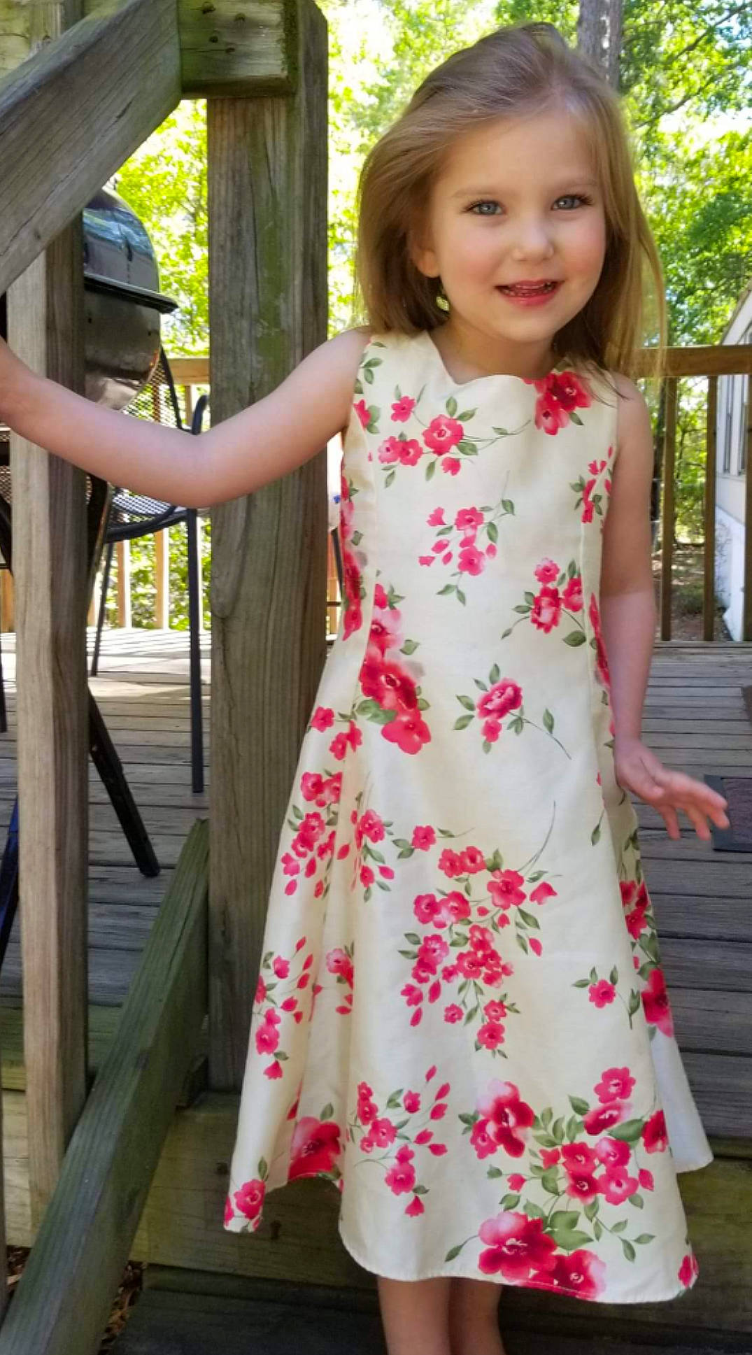 Kinzlee is registered to the contest to win money with this photo: child, child_model, clothing, day_dress, dress, formal_wear, joy, neck, pattern, peach, person, pink, plant, sleeve, textile, toddler, waist, wildflower
